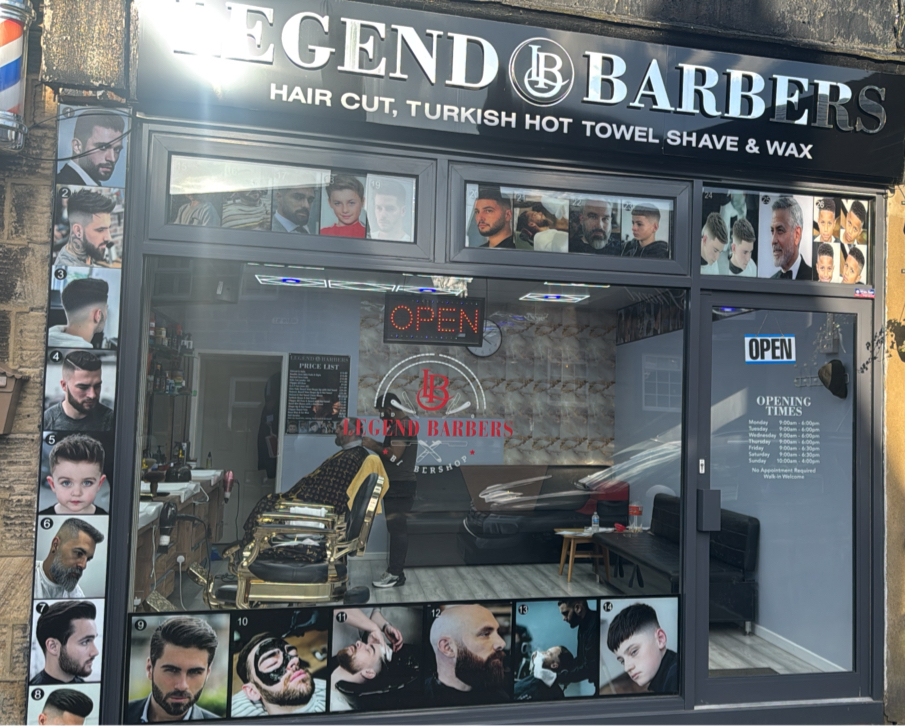 The black Legend Barbers fascia and shop entrance on Main Street, Menston
