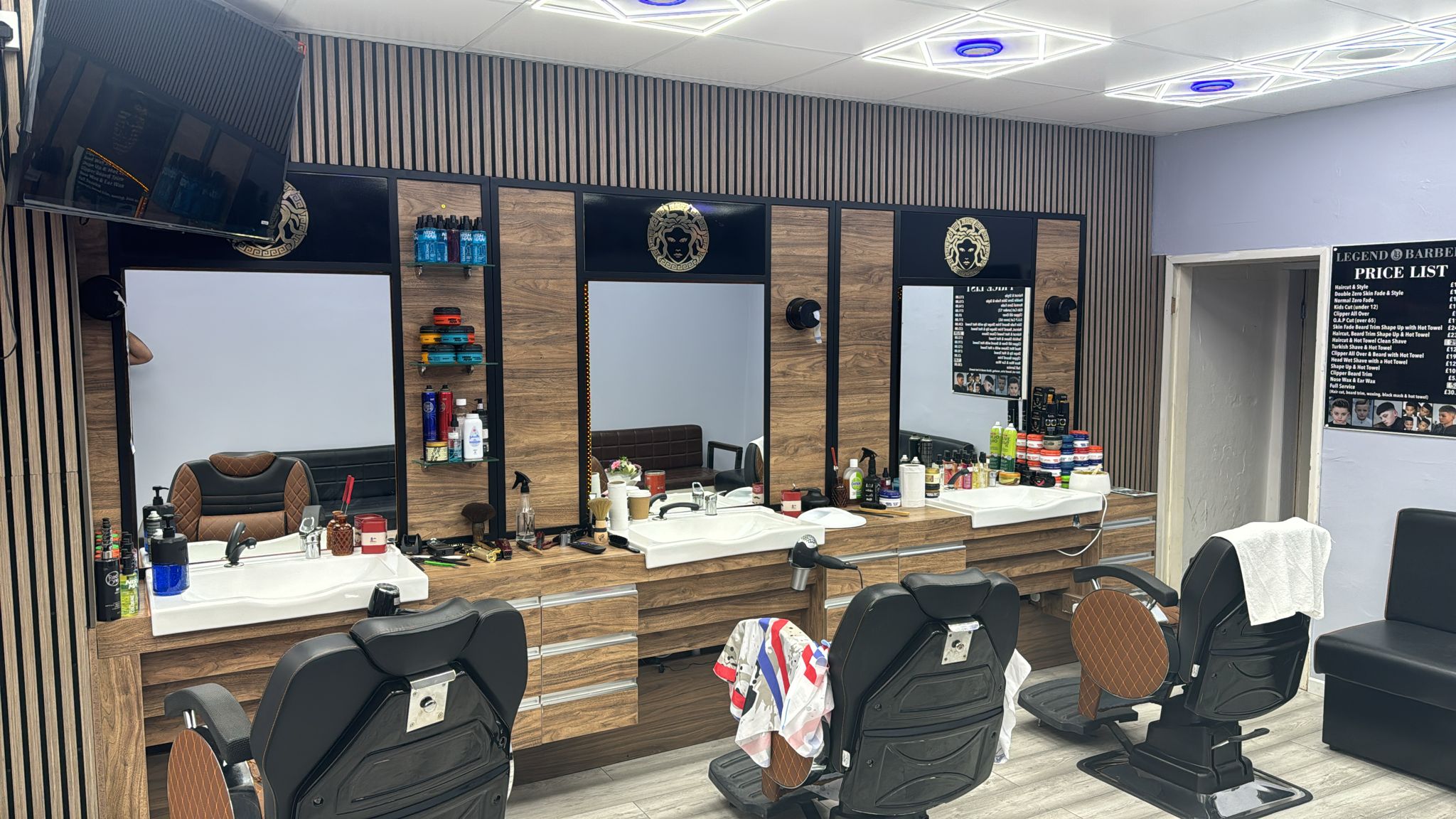 The barber chairs and wood-panelled mirrors inside Legend Barbers