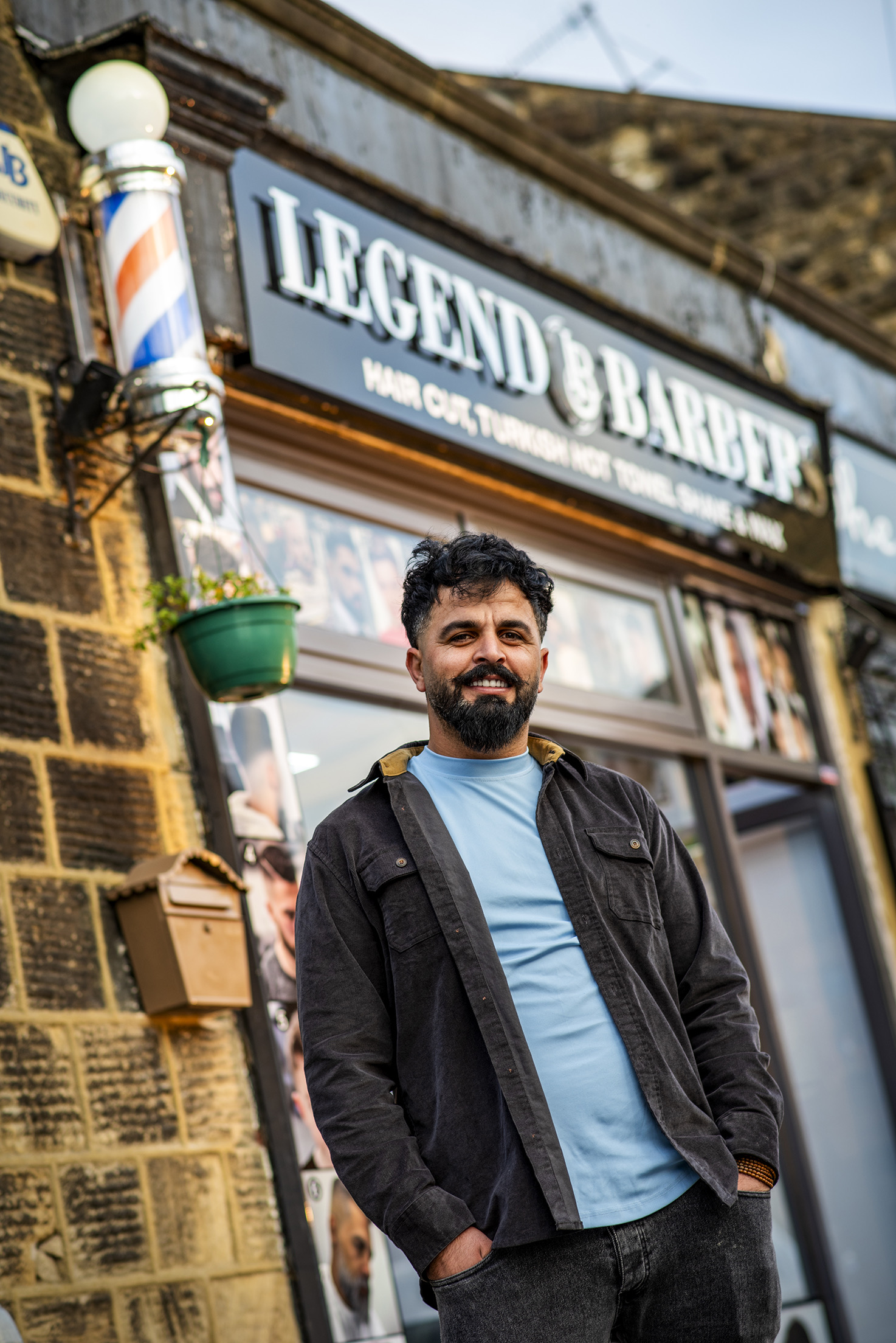 A portrait outside the Legend Barbers shopfront on Main Street